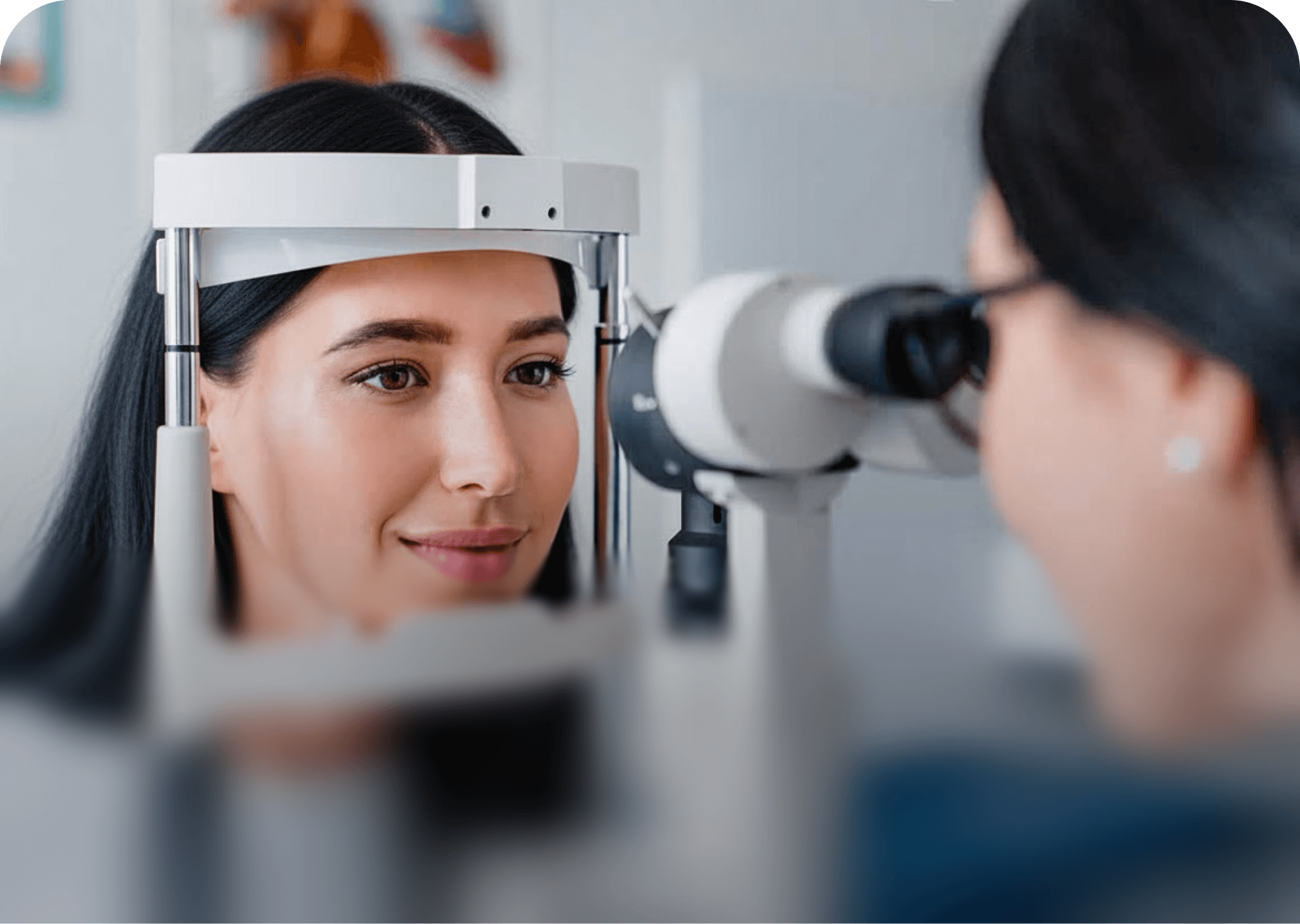 Close-up of a smiling patient undergoing an automated keratometry measurement, highlighting the relaxed and professional environment during a Dresden Vision Australia eye test.