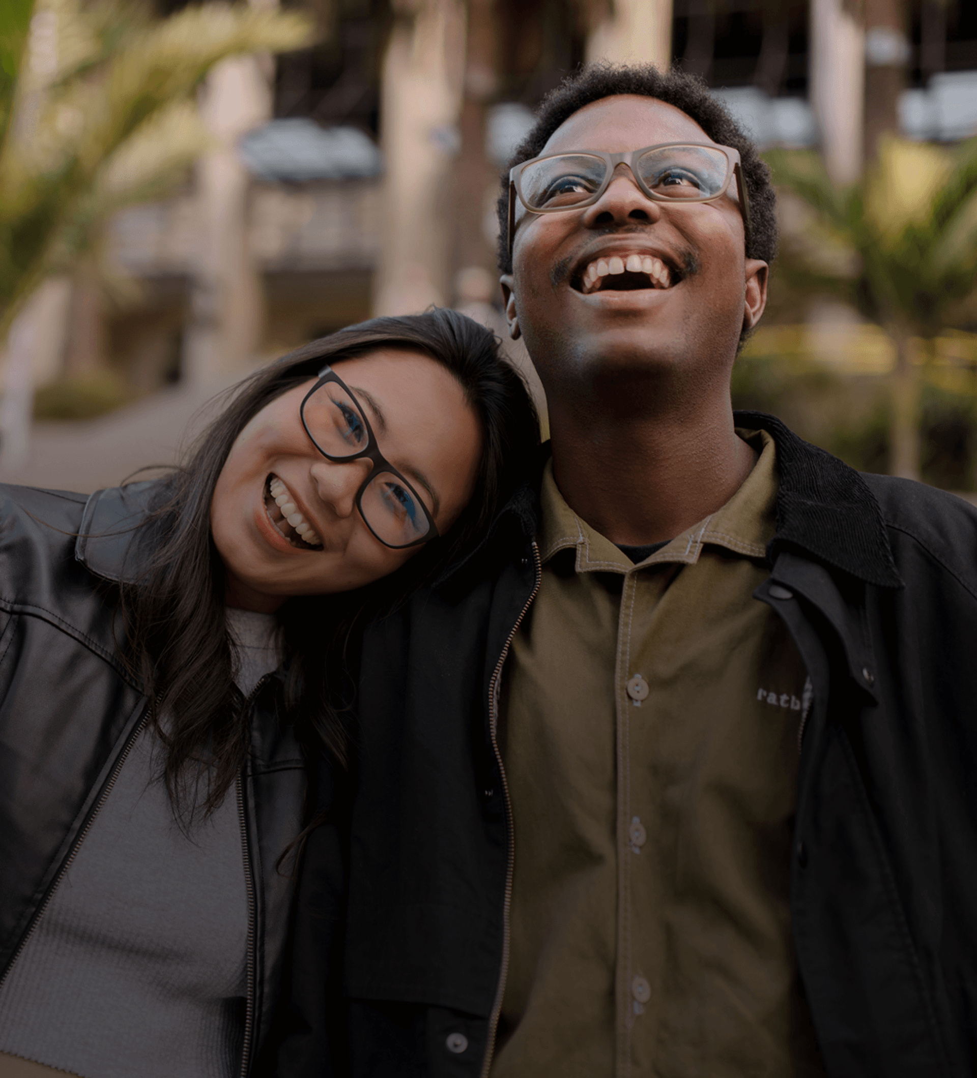 Smiling couple outdoors wearing Dresden Vision Australia eyeglasses, showcasing comfortable single vision lenses for everyday distance and reading use