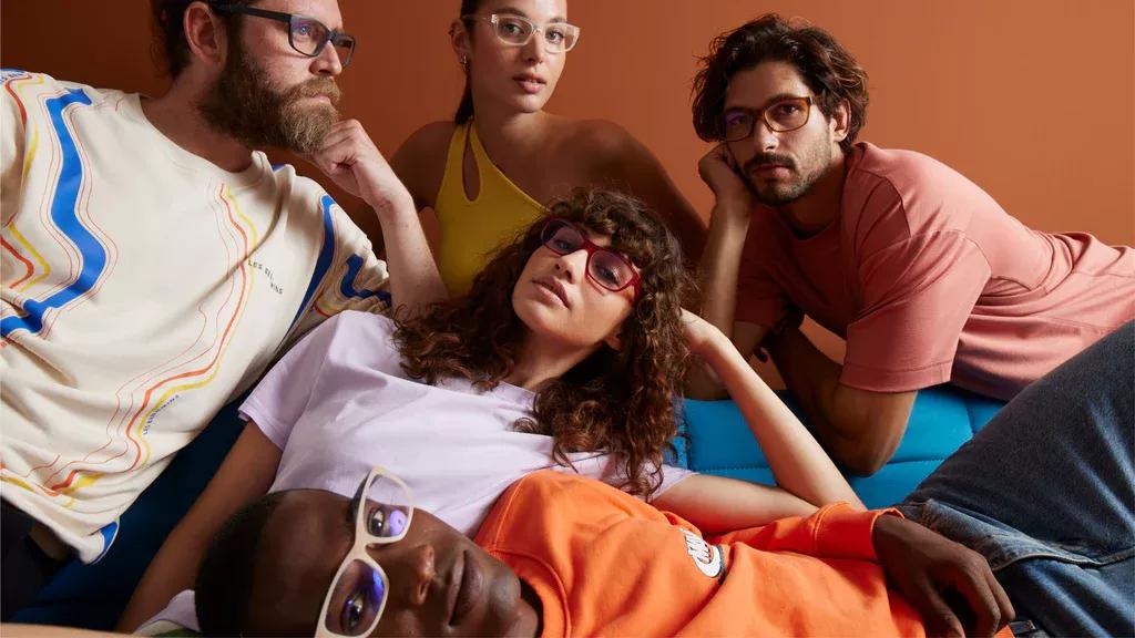 A group of people wearing Dresden eyeglasses of different color. There are a total of 5 people, 2 woman, and 3 man, all wearing Dresden eyeglasses. 