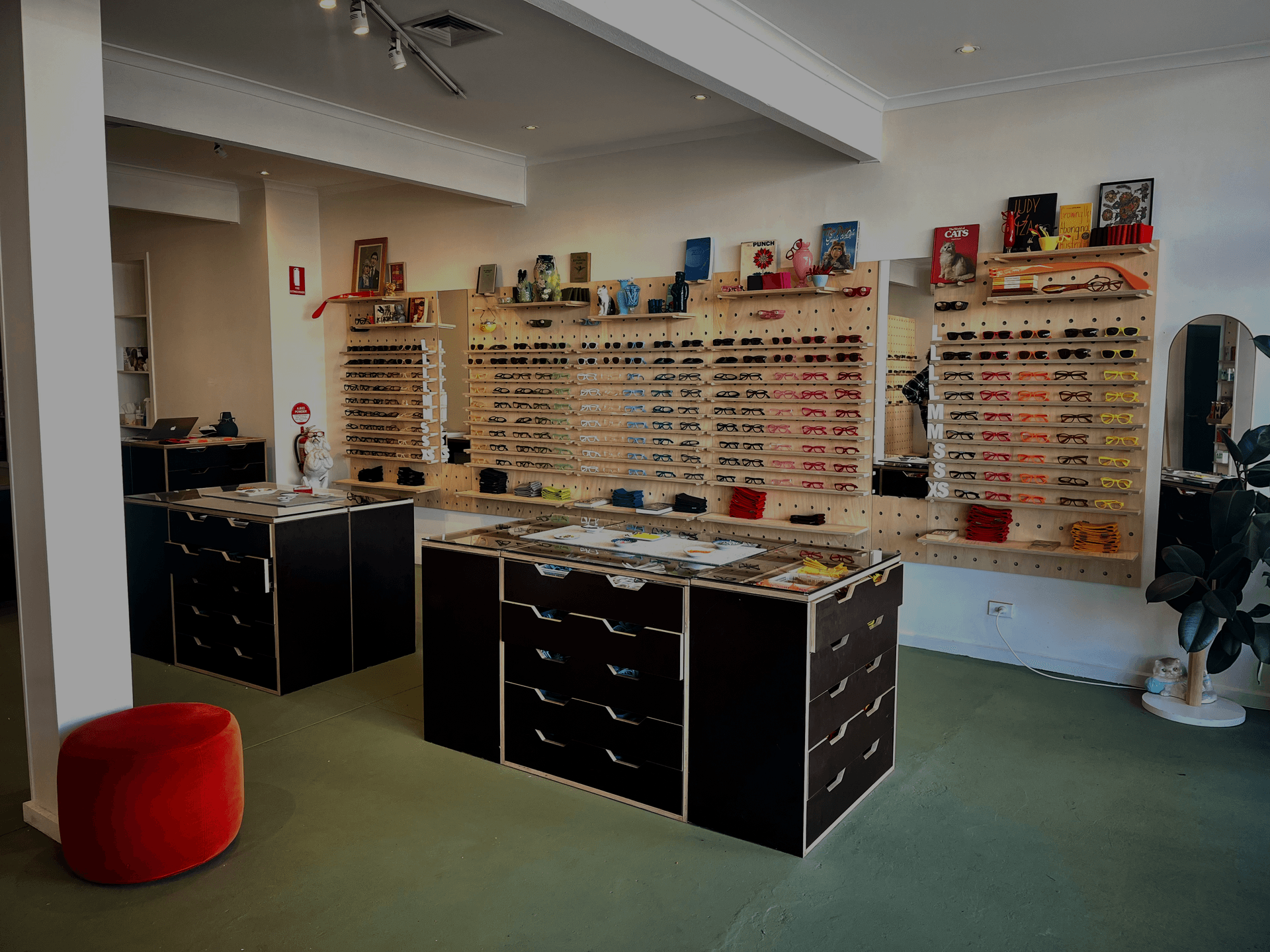 Interior of Dresden Vision Fitzroy optical store featuring colorful eyewear frames on wooden pegboard displays